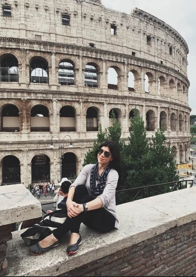 Seated in front of the Colosseum